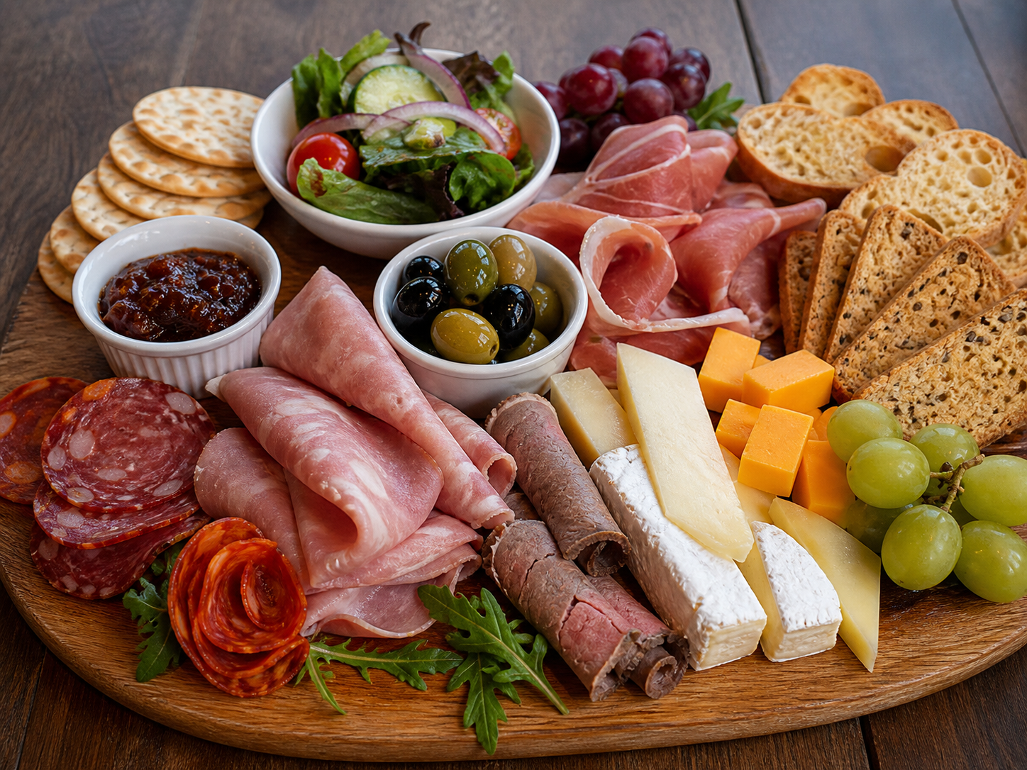 Bistro board with meats, cheeses, olives and chutney